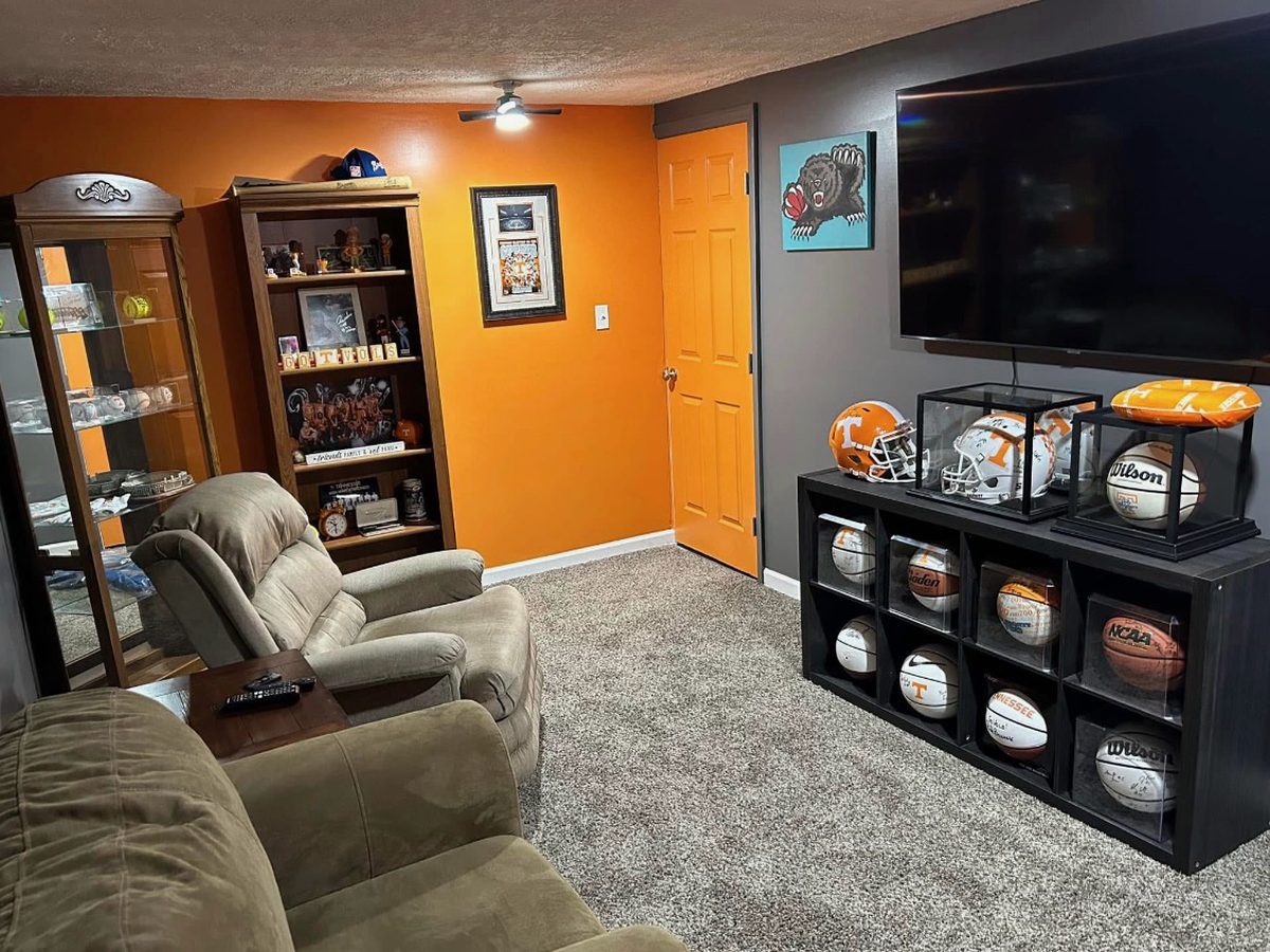 After: finished basement rec room with carpet, painted walls and a TV wall